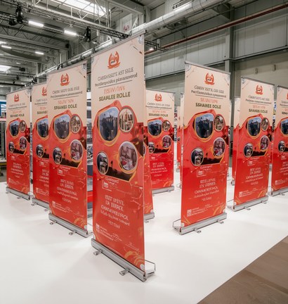 Row of branded roll-up standees set up at an exhibition